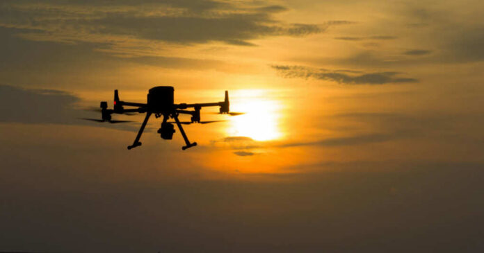 shutterstock2506644171jpg A silhouette of a drone flying against a sunset sky