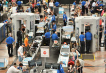 CDC’s Hidden Agenda? New Ebola Restrictions Questioned Busy airport security checkpoint with travelers and TSA agents