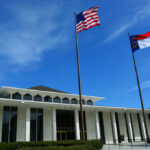Digital Snooping Explodes in ‘Homewrecker’ Cases Government building with American and North Carolina flags under a clear blue sky