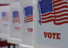 Redrawing Maps: Could This Sabotage Fair Votes? Voting booths with American flags and VOTE signage