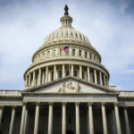 Congress Clashes Over Trump’s Costly War The U.S. Capitol building with an American flag flying in front