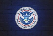 Fraud Crackdown Targets Immigration Lawyers Logo of the U.S. Department of Homeland Security on a blue wall