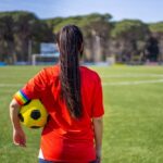 Governor’s Inaction Leaves Female Athletes Furious A young female soccer player standing on a field holding a ball