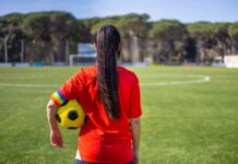 Governor’s Inaction Leaves Female Athletes Furious A young female soccer player standing on a field holding a ball
