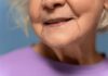 Close-up of an elderly woman's face with a gentle smile