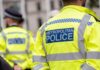 UK Rally Chaos: Controversy Over Speech Limits Uniformed Metropolitan Police officers standing in a public area