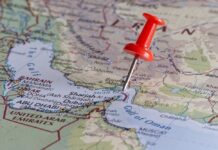 A red pushpin on a map of the Middle East highlighting a specific location