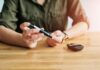 Person using a blood glucose meter and a pen device for diabetes management