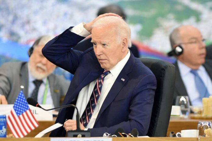 A political leader in formal attire appears deep in thought during a meeting