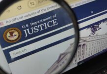 Biden Fights DOJ Over Explosive Audio Close-up view of the U.S. Department of Justice website through a magnifying glass