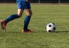 Shocking Soccer Espionage: Clubs Clash Over Spying Youth soccer player dribbling a ball on a field