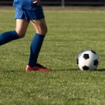 Shocking Soccer Espionage: Clubs Clash Over Spying Youth soccer player dribbling a ball on a field
