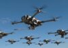 A fleet of drones flying in a clear blue sky