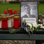 Cameras Roll in Court Despite Defense Plea Memorial setup with candles, flowers, and a framed photograph