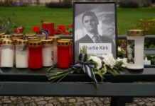 Cameras Roll in Court Despite Defense Plea Memorial setup with candles, flowers, and a framed photograph