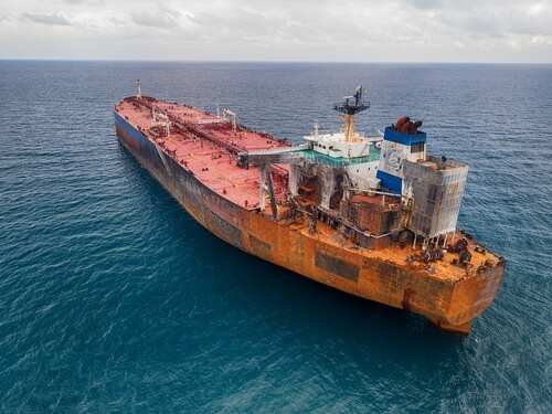Aerial,Drone,Footage,Of,The,Sanctioned,Russian,"shadow,Fleet",Tanker Aerial view of a large, rusty oil tanker in the ocean