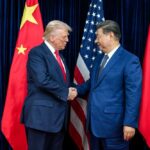 Trump Leads CEOs to Beijing – BILLIONS at Stake! Two political leaders shaking hands in front of national flags