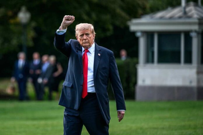 Washington,,D.c.,Usa,,September,11,,2025,,,President,Donald,Trump A political figure walking outdoors with a raised fist