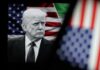 Donald Trump in front of an American flag, displaying a serious expression