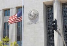 Trump Names Lawyer To Manhattan Post United States courthouse facade with American flag at half-mast