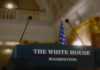 White House Plot—or Panic? Press podium with microphones and an American flag in the background