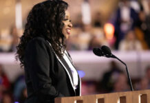 Backlash Explodes Over ‘Not Deadly’ Knife Claim A woman in formal attire speaking at a podium with microphones