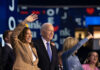 Group of political figures waving at an event, smiling and engaging with the audience