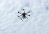 A drone flying against a cloudy sky