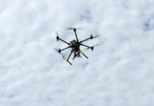 Drone Swarms Loom—Are Bases Actually Naked? A drone flying against a cloudy sky