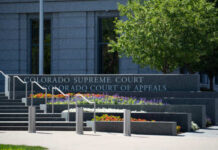 Exterior view of the Colorado Supreme Court building with landscaped flowers
