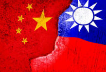 Taipei Invites Snitches—Global Spy Game Escalates A visual representation of the flags of China and Taiwan with a distressed texture