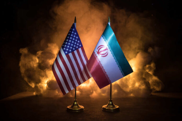 Usa,And,Iran,Small,Flags,On,Burning,Dark,Background.,Concept Flags of the United States and Iran displayed together