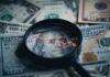 Economic Reset or Power Grab? Magnifying glass over US dollar bills with stock market data displayed
