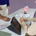 Federal Sweep Hits Local Voter Rolls Individuals participating in the voting process at a polling station