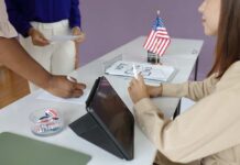 Federal Sweep Hits Local Voter Rolls Individuals participating in the voting process at a polling station