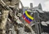 Rescue workers search a collapsed building site