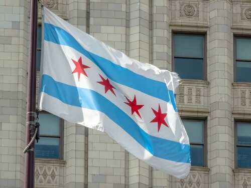 The,Chicago,City,Flag,Waves,Proudly,Against,A,Classic,Stone Chicago flag waving in front of a building