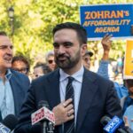 Defy SCOTUS? Senator Slams NYC Mayor A politician speaking at a rally with supporters holding signs