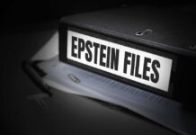 A black binder labeled 'Epstein Files' with papers and a pen beside it