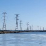 How Vulnerable Is America’s Grid? Wind turbines and solar panels in a scenic landscape