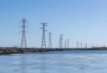 How Vulnerable Is America’s Grid? Wind turbines and solar panels in a scenic landscape