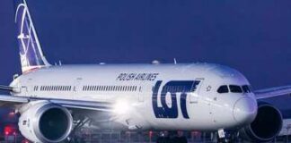 An airplane parked at Ben Gurion Airport with the terminal in the background