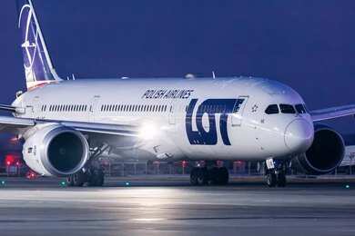 An airplane parked at Ben Gurion Airport with the terminal in the background
