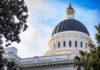 Corruption Probe Rocks Sacramento Insiders Capitol building dome framed by trees against a blue sky