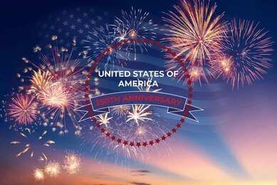 Fireworks burst over a twilight sky with a USA anniversary emblem