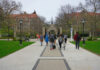 New Florida Rule Reshapes College Access Students walking along a pathway on a university campus with historic buildings in the background
