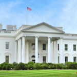 Election Rebel Lands White House Moment The White House with an American flag flying above, surrounded by greenery