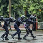 Police tactical team advancing in rain