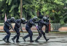 Police tactical team advancing in rain