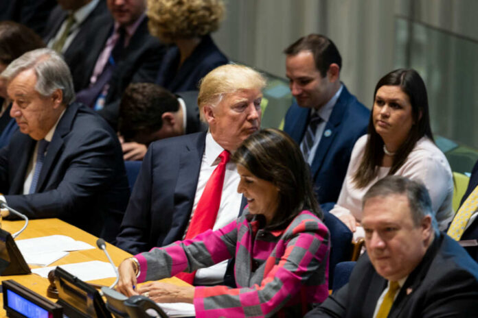 shutterstock_1187477929 A group of political leaders seated at a United Nations meeting, engaged in discussion